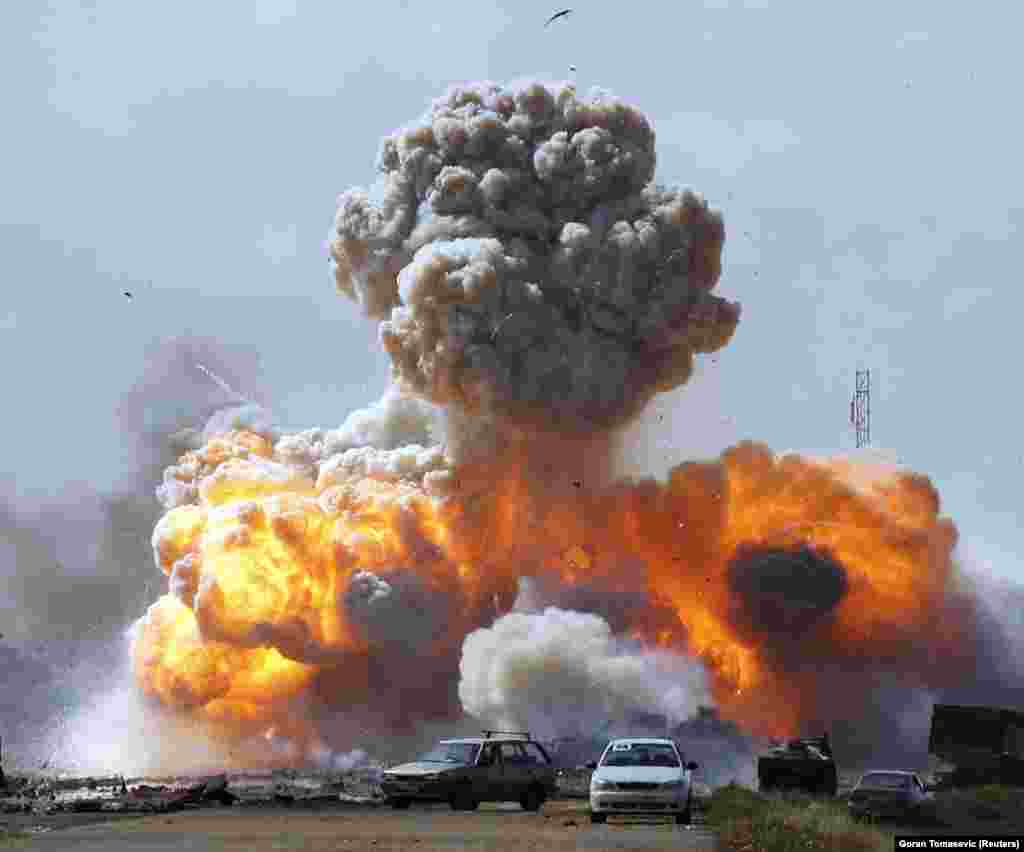 Vehicles belonging to forces loyal to Libyan leader Qaddafi explode after a coalition air strike in March 2011. &quot;After [this picture] I went closer,&quot; he told the British Journal of Photography. &quot;There was another explosion which knocked me down but the picture was not [as good as] this one.&quot;