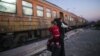 A woman and her child prepare to board a train heading to Serbia after crossing the Greek-Macedonian border on November 12, 2015.