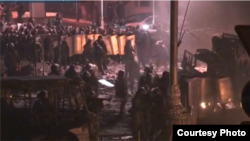 Police and protesters face off in Kyiv in the early morning hours of January 21, after a tense night that saw Molotov cocktails, bottle rockets, and stun grenades exchanged between protesters and police.
