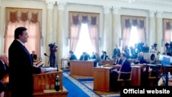 Ukrainian President Viktor Yanukovych (left) speaks during a televised cabinet meeting in Kyiv on March 7.