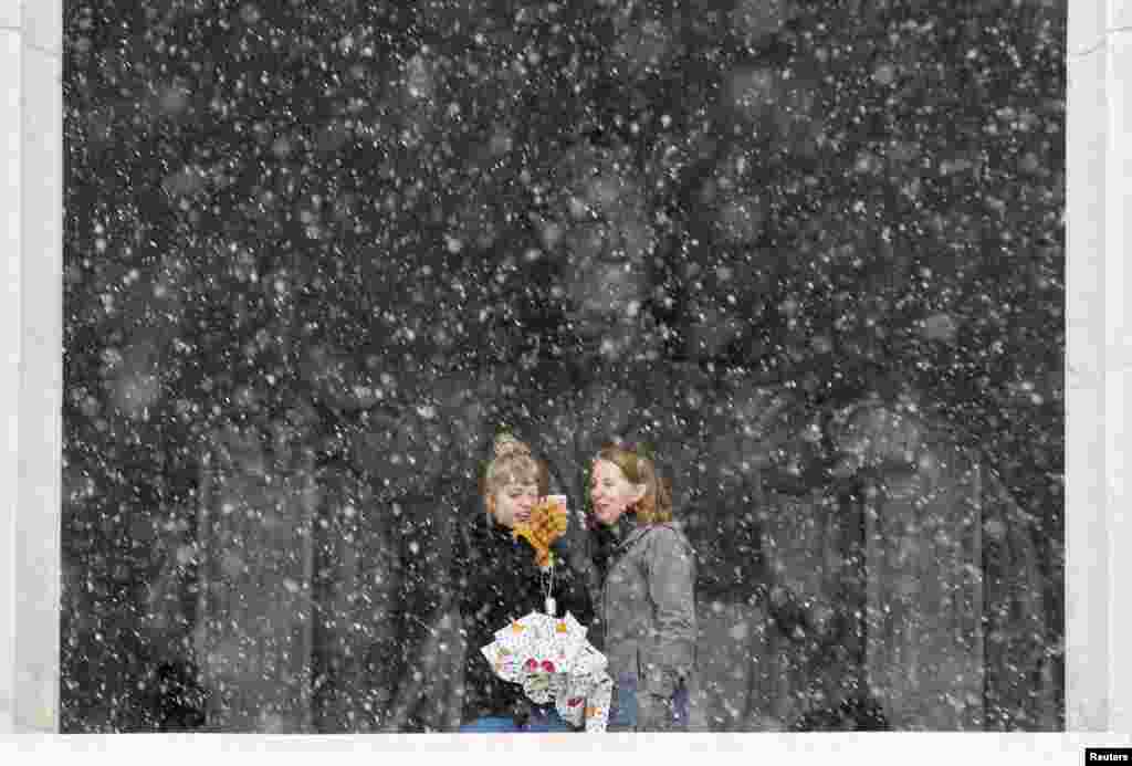 Women take pictures at the Lincoln Memorial during a snowstorm in Washington, D.C. (Reuters/Joshua Roberts)