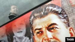 A city bus decorated with a portrait of Josef Stalin on the street in St. Petersburg