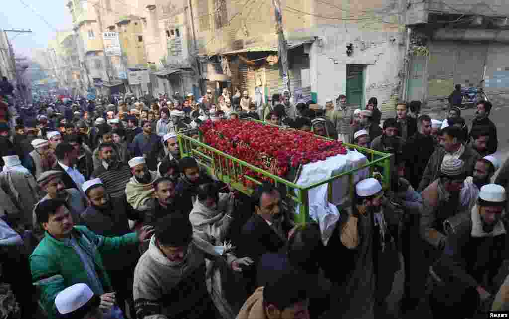 People carry the coffin of a male student who was killed in an attack by Taliban gunmen on a Pakistani army school in Peshawar that killed scores of people, mostly children. (Reuters/Fayaz Aziz)