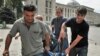 Men carry the body of a man killed by a shell in the town of Gori on August 12