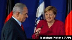 Israeli Prime Minister Benjamin Netanyahu and German Chancellor Angela Merkel give a joint press conference at a hotel in Jerusalem, October 4, 2018