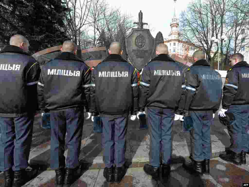 Belarusian police pay their respects at a monument in Minsk dedicated to officers killed in the line of duty. - Photo by Viktor Drachev for AFP