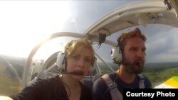 Pilot Tomas Mazetti (right) and Hannah Lina Frey in the single-engine 1968 Jodel plane that they flew for "Teddybear Airdrop Minsk 2012" in July 2012.