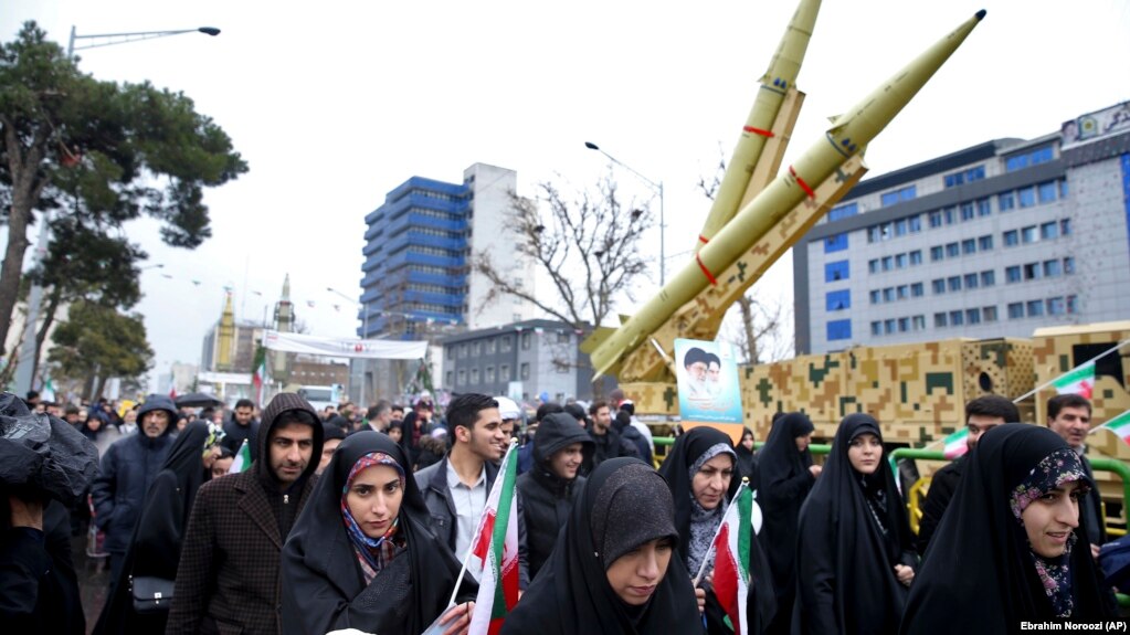 Iranians walk past a missile during a rally marking the 40th anniversary of the 1979 Islamic Revolution in Tehran on February 11.
