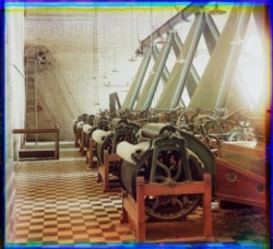 Machines spin thread inside a cotton mill, probably in Tashkent.