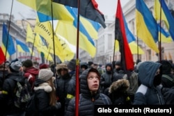 People attend a rally in front of the Ukrainian parliament on January 16, calling for lawmakers to recognize Russia as an aggressor state and implement other legislative changes concerning the occupied parts of eastern Ukraine.