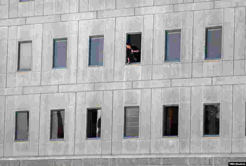 An Iranian policeman looks out of the parliament building in central Tehran.