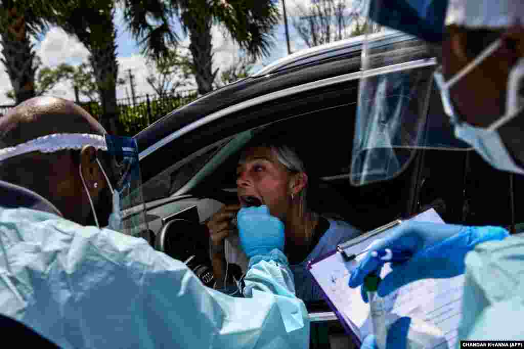 Medical personnel take samples at a &quot;drive-thru&quot; coronavirus testing lab set up by a local community center in West Palm Beach, Florida. (AFP/Chandan Khanna)