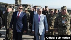 Armenia - President Serzh Sarkisian and Russian Defense Minister Anatoly Serdyukov (L) monitor CSTO military exercises at the Marshal Bagramian training ground, 19Sep2012.