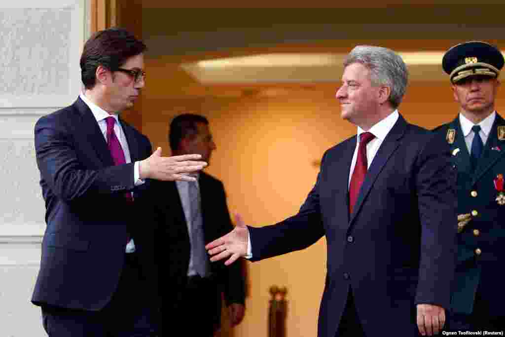 Newly elected President of North Macedonia Stevo Pendarovski prepares to shake hands with outgoing president Gjorge Ivanov, after his inauguration ceremony in Skopje, North Macedonia, May 12, 2019. REUTERS/Ognen Teofilovski