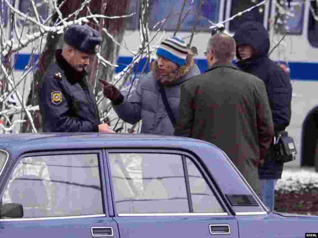 The same two men joined Milov in his demonstration -- but they remained free after Milov was detained.