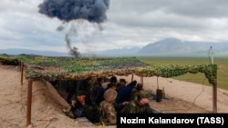 Military officers take part in a command-staff exercise by a joint Russian-Tajik force at Kharbmaidon, next to the border with Afghanistan, in March.