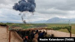 FILE: A joint Russian-Tajik military exercise near the Afghan border in March 