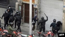 Iranian security forces on motorcycles surround opposition protesters during clashes in Tehran on December 27, 2009.