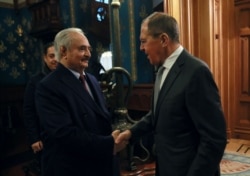 The commander of the Libyan National Army, Khalifa Haftar, shakes hands with Russian Foreign Minister Sergei Lavrov before talks in Moscow on January 13.
