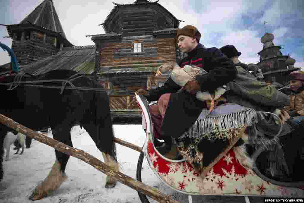 A man holds a goose before traditional goose fights at the Maslenitsa festival at the Museum of Wooden Architecture in the town of Suzdal on February 29, 2020.