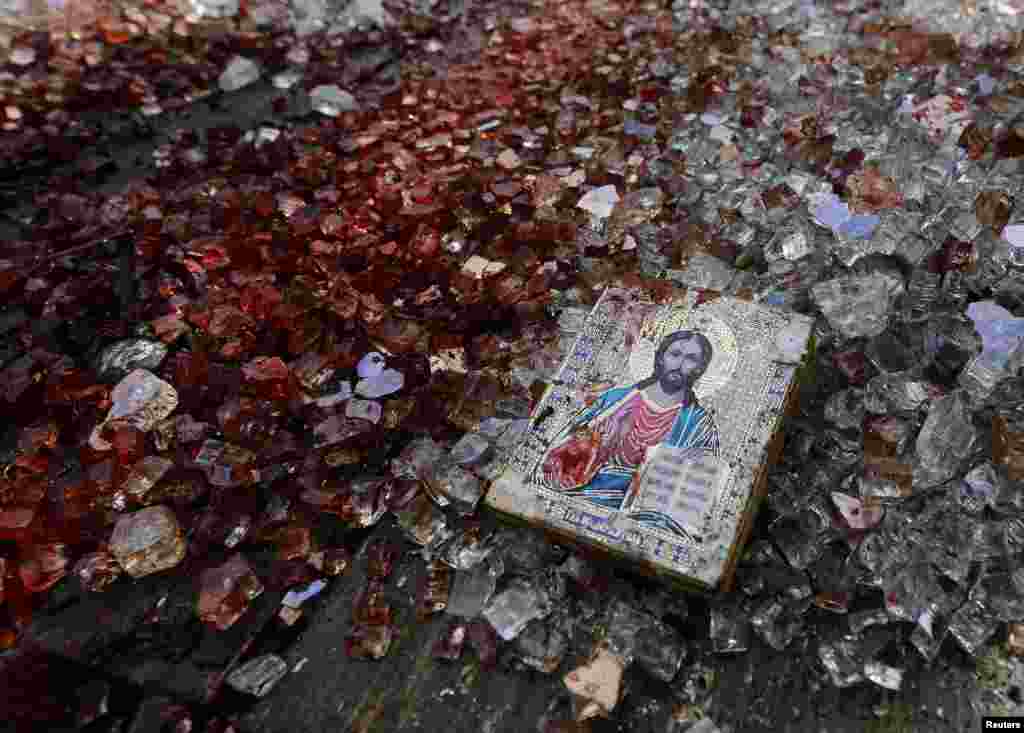 A bloodstained icon of Jesus is seen among shattered glass atop a wrecked KamAZ truck near the Donetsk airport in eastern Ukraine following a gunbattle on May 26-27. (Reuters/Yannis Behrakis)