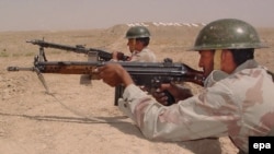 Pakistani border guards observe the Afghan desert at the Pakistan-Afghanistan border