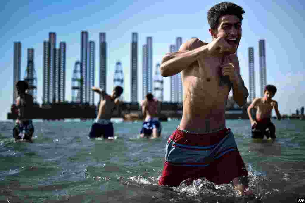 Teenagers from a boxing school take part in a training session in the Caspian Sea near Soviet oil rigs in the Azerbaijani capital, Baku. (AFP/Kirill Kudryavtsev)