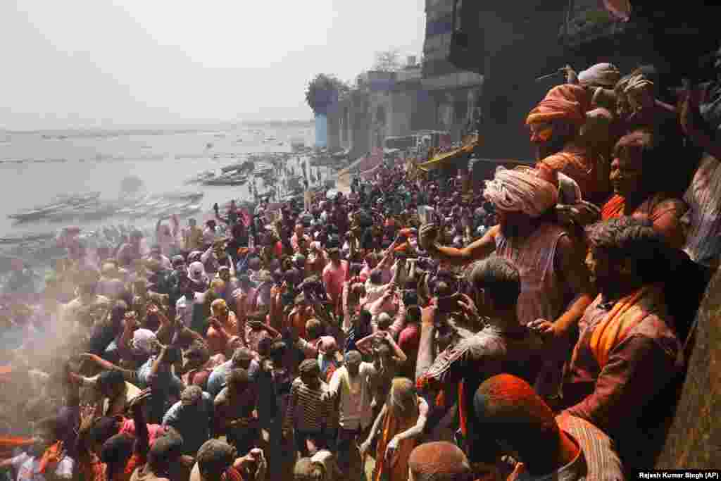 Hindu devotees play with ash and colors at a cremation ground on the banks of River Ganges in Varanasi, India. (AP/Rajesh Kumar Singh)