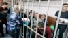 Former prison guards of the Correctional Colony No. 1 in Yaroslavl attend a court hearing in Yaroslavl on February 21.