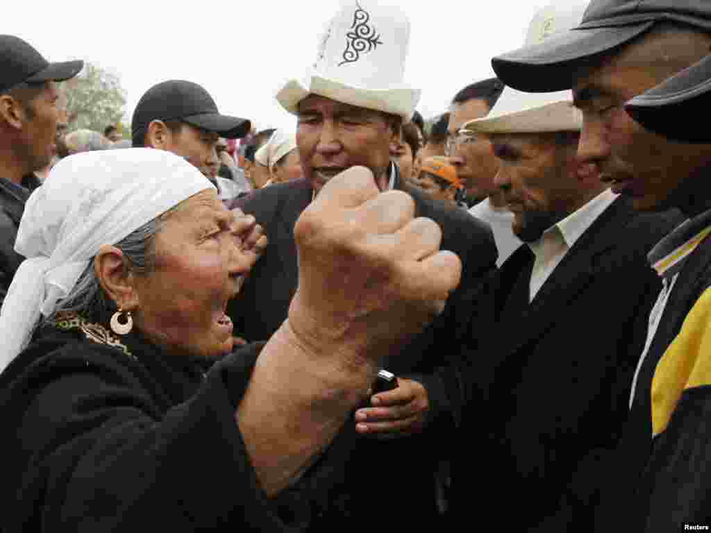 Meanwhile, clashes broke out in Jalal-Abad between Bakiev's supporters, like the woman pictured, and backers of the interim government calling for his resignation.