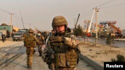 British soldiers block the road at the site of a suicide attack in Kabul on January 5.