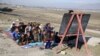 Afghan children attend class outside due to a lack of school facilities in Laghman Province. (file photo)