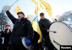 Demonstrators shout slogans while they take part in a rally of depositors in failed Ukrainian banks who demanded compensation of their deposits, in front of the parliament building in Kyiv on November 15.