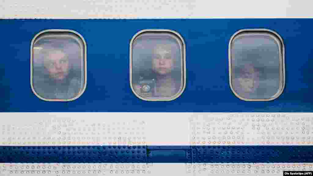 Children from the region around Chernobyl in Ukraine look out the window of a plane after arriving in Hanover, Germany. Children suffering health consequences of the Chernobyl nuclear accident were invited by the regional Evangelical Lutheran Church and will stay for four weeks with German host families. (AFP/dpa/Ole Spata)