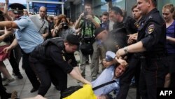 Полиция гей белсенділер мен қарсыластарын арашалап жатыр. Мәскеу, 11 маусым 2013 жыл.