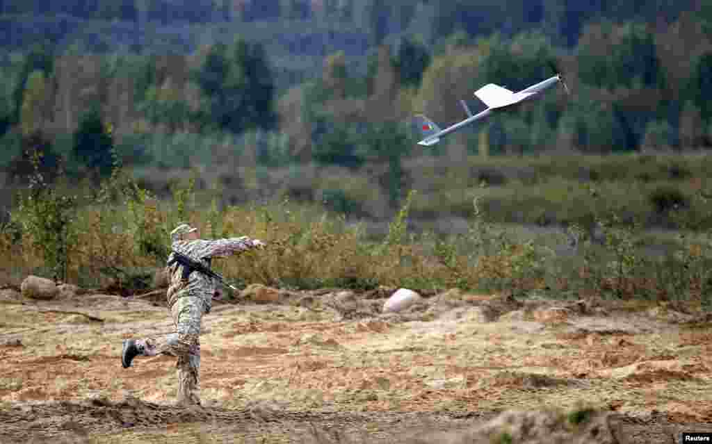 A soldier sets off a drone at a military ground near the town of Osipovichi, Belarus. (Reuters/Vasily Fedosenko)