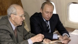 Russian President Vladimir Putin with a World War II veteran on board the presidential plane to a ceremony to mark the 60th anniversary of the liberation of Auschwitz in 2005.