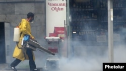 Armenia -- A worker disinfects streets in Yerevan, April 22, 2020.