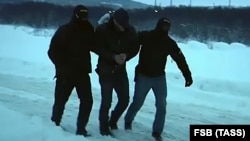 FSB officers detain a supporter of the Right Sector group in the northwestern city of Murmansk on December 11.