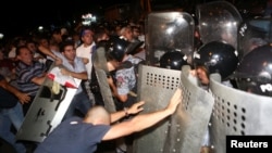 Armenia - Riot police clash with demonstrators who had gathered in a show of support for gunmen holding several hostages in a police station in Yerevan, Armenia, July 20, 2016