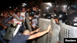 Armenia - Riot police clash with demonstrators who had gathered in a show of support for gunmen holding several hostages in a police station in Yerevan, Armenia, July 20, 2016