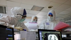 Iranian medical personnel, wearing protective gear, work at the quartine ward of a hospital in Tehran on March 1, 2020.