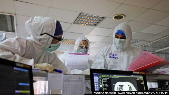 Iranian medical personnel wearing protective gear work at the quarantine ward of a hospital in Tehran on March 1.