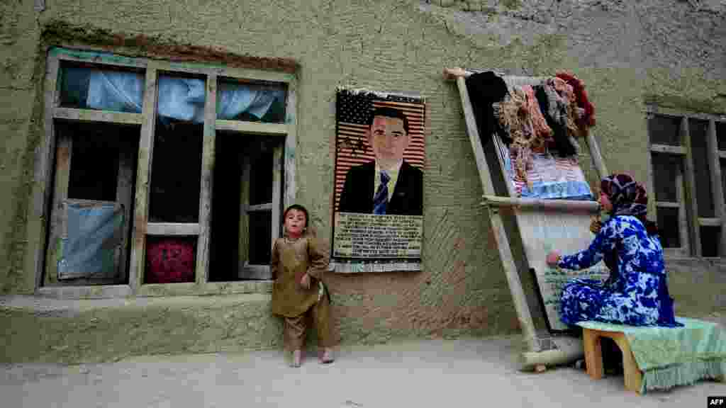 A 15-year-old girl works on a carpet at her home in Jowzjan, in Afghanistan's Sheberghan Province. (AFP/Qais Usyan)