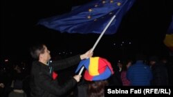 A protester waves and EU flag at a demonstration in Romania's Victory Square on February 26.