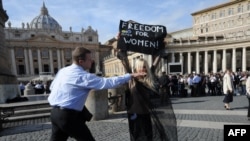 A Femen activist is stopped by security in front of St Peter's Basilica in Rome in November.