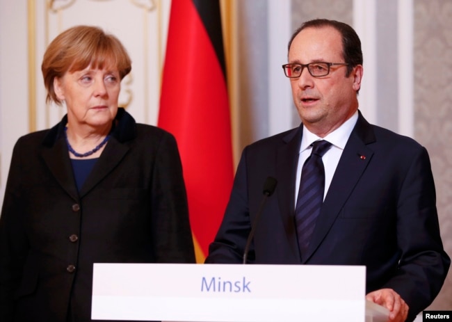 German Chancellor Angela Merkel (left) and French President Francois Hollande address the media after taking part in peace talks on resolving the Ukrainian crisis in Minsk on February 12, 2015.