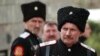 Cossacks and bikers in leather jackets gather in front of St. Nicholas Church in Kotor, Montenegro, where they listened to the liturgy of priest Momcilo Krivokapic.