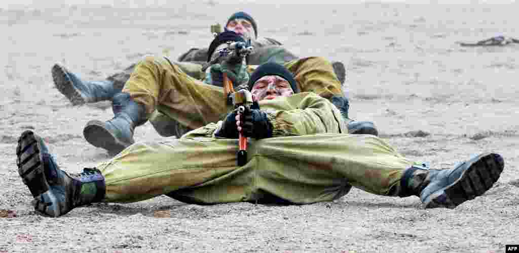 Russian riot police display their shooting skills during a ceremony marking the 20th anniversary of OMON, the Russian Interior Ministry's special police force, in St. Petersburg. (AFP/Olga Maltseva)