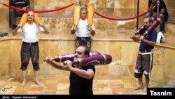 Men practicing an ancient Iranian sport at a special gym called zourkhaneh at Qasr Prison on August 1, 2015. FILE PHOTO.